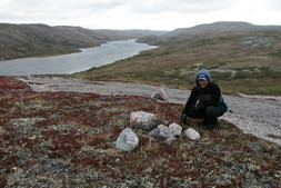 Peter near a collapsed inukshuk, facing east