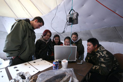 Natalie Echalook shows photos of site IbGk-3 to visitors, 2007