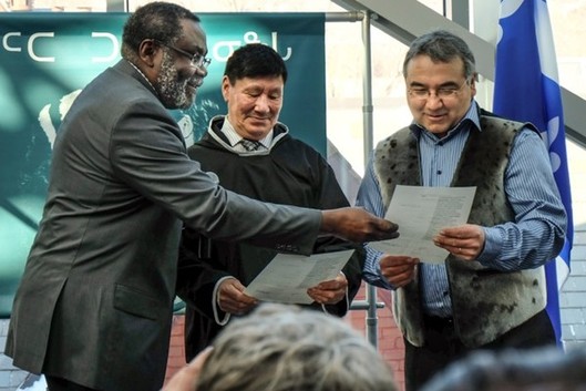 Maka Kotto giving to Charlie Arngak and Jobie Tukkiapik the designation notice of katajjaniq