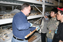 Louis G. showing an item to the children explaining preservation techniques at the CDCM. (Photo by Andrew Epoo)